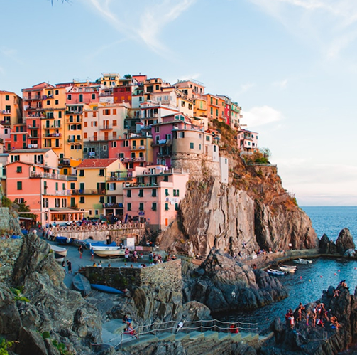 The colorful cliffside village of Manarola, Italy, with bright houses stacked above the blue sea